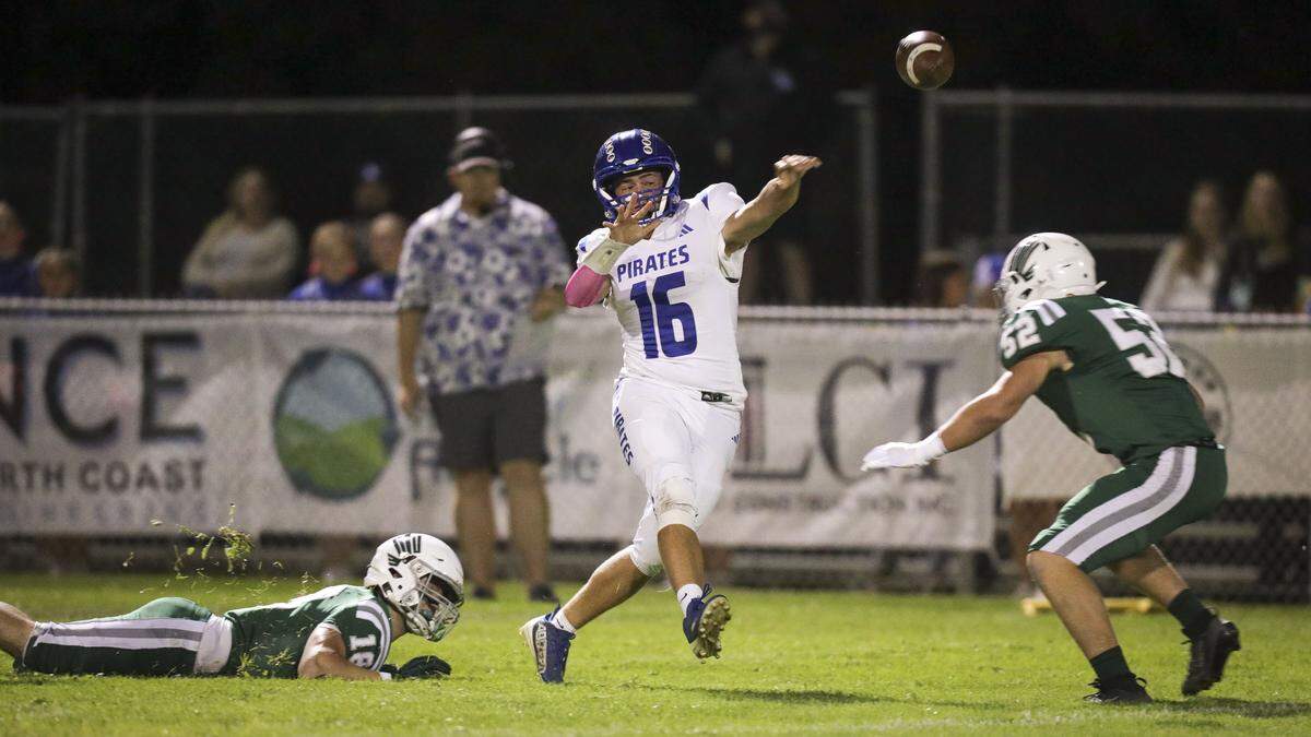 Sands Dougherty was under pressure to throw most of the night. Nick Capaci at left, and Garret Davis surround him. Templeton beat Morro Bay 56-14 in football game seen here on Oct. 9, 2025.