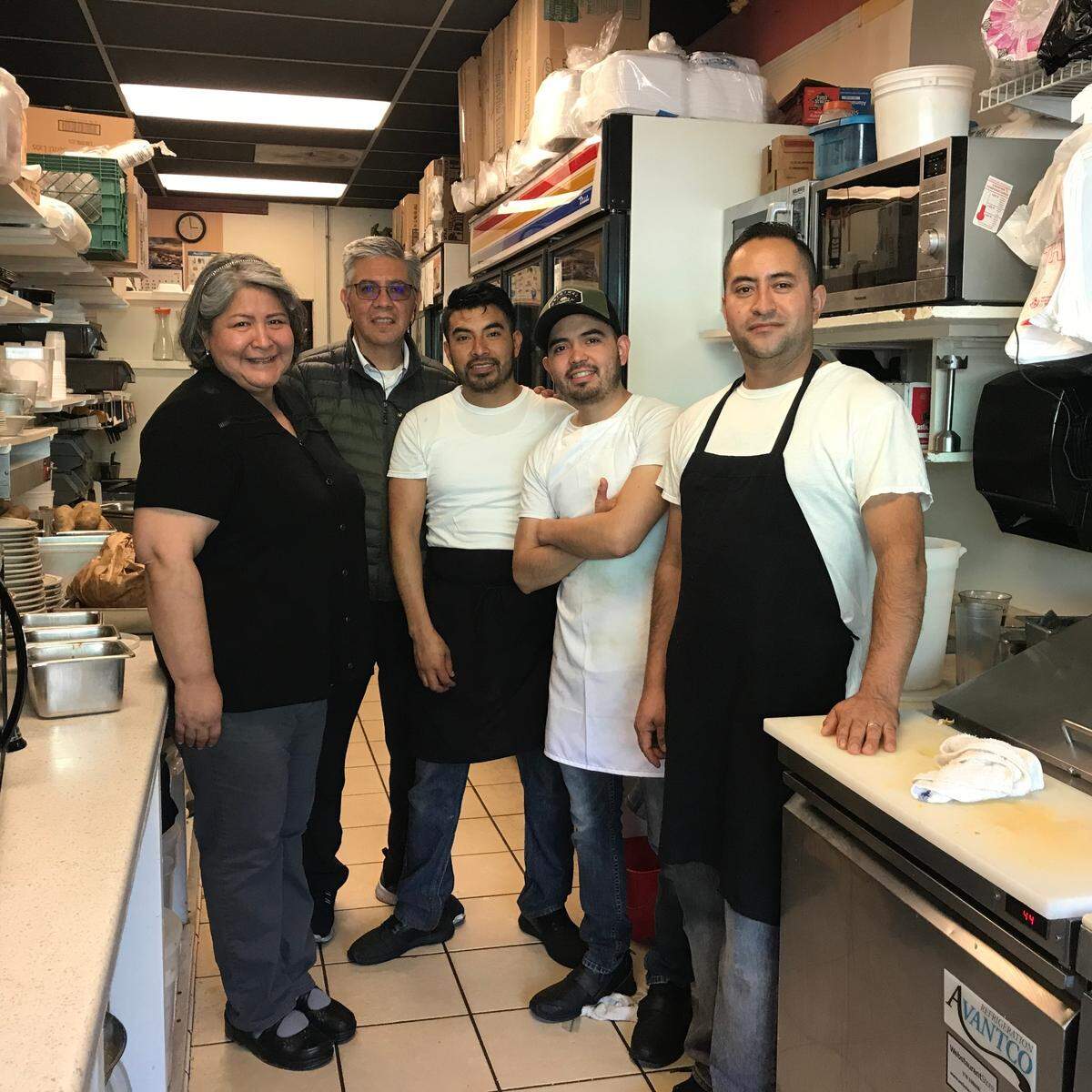 Left to right, Cambria Cafe owner Nanyeli Mendoza poses for a photo with employees Rafael Mendoza, Josue Garcia, Uriel Alcantor and Tachometer Velasquez. Mendoza is closing the coffee shop after two decades.