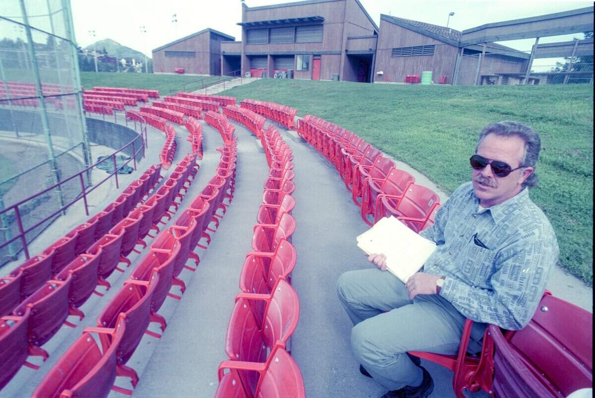 COMFY: San Luis Obispo parks supervisor Larry Tolson tests the new seats at SLO Stadium. The more than 800 orange chairs were purchased from Anaheim Stadium, home of the Angels. Seen here on Jan. 28, 1998.