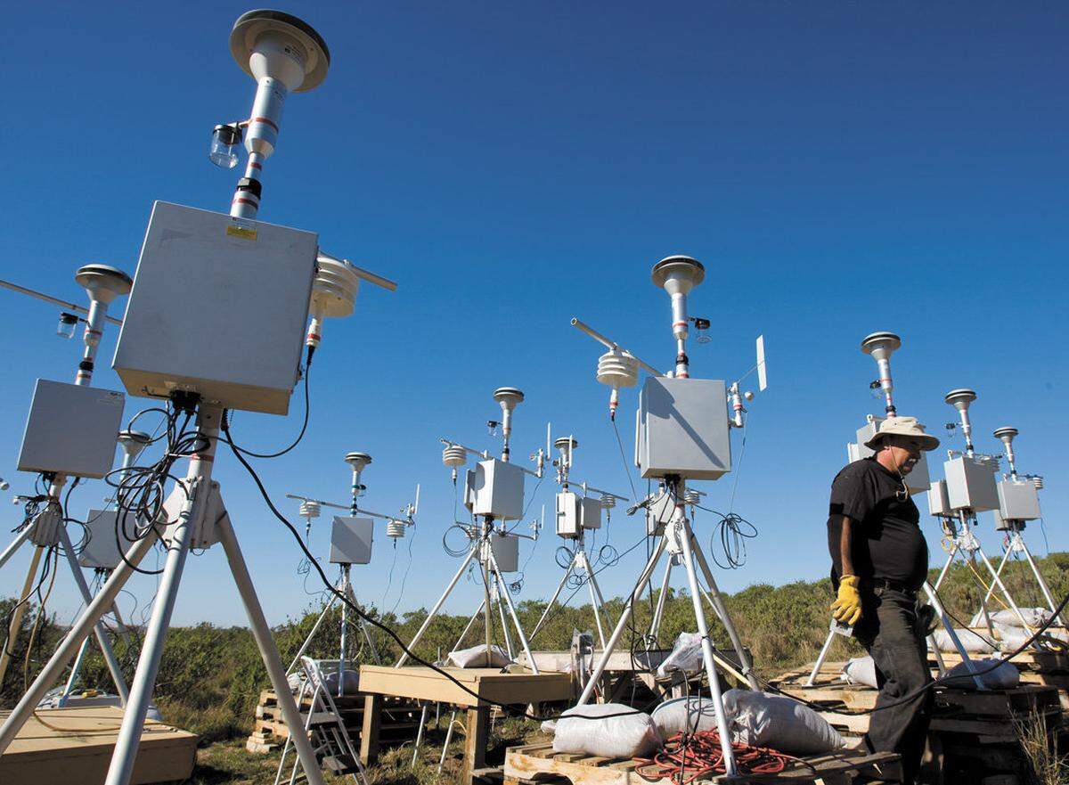 Brian Aunger, Air Pollution Control District engineer, walks among air sampling monitors in February 2012. The monitors were deployed across the Nipomo Mesa and measure how different locations are affected by particulate air pollution from the Oceano Dunes.