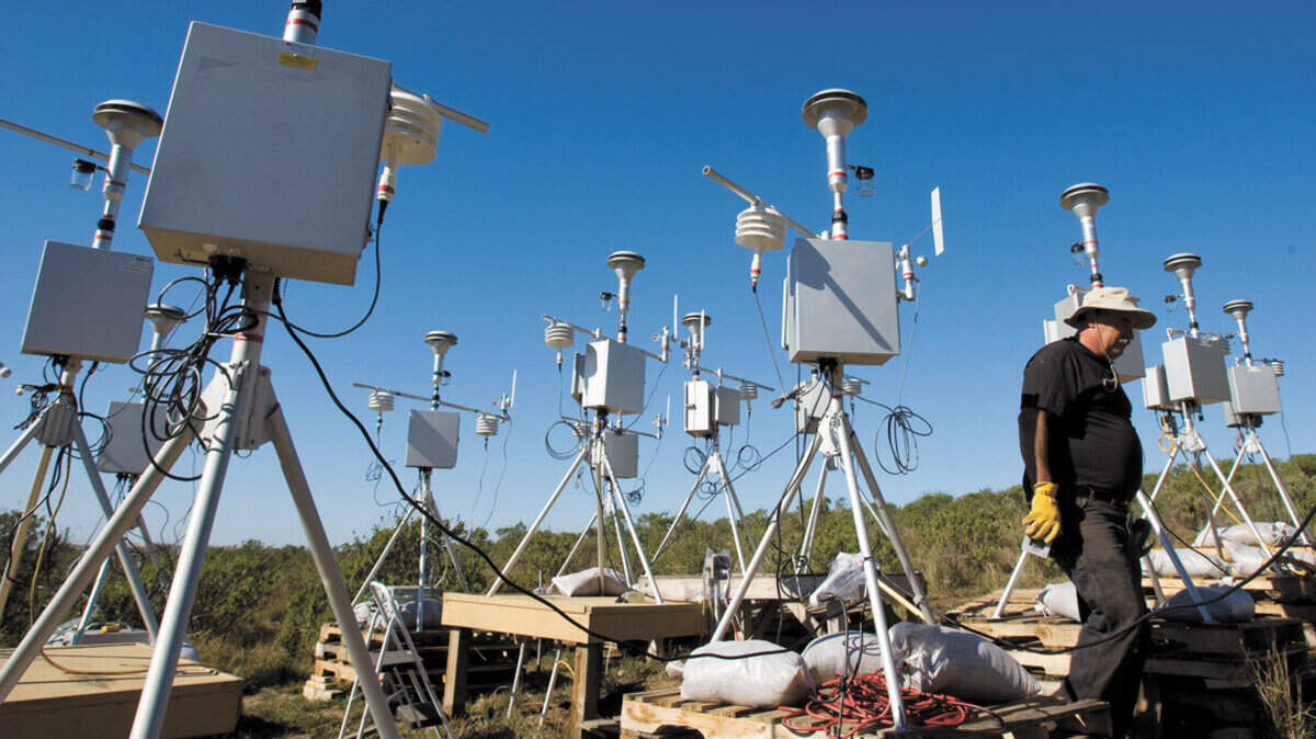 Brian Aunger, Air Pollution Control District engineer, walks among air sampling monitors in February 2012. The monitors were deployed across the Nipomo Mesa and measure how different locations are affected by particulate air pollution from the Oceano Dunes.