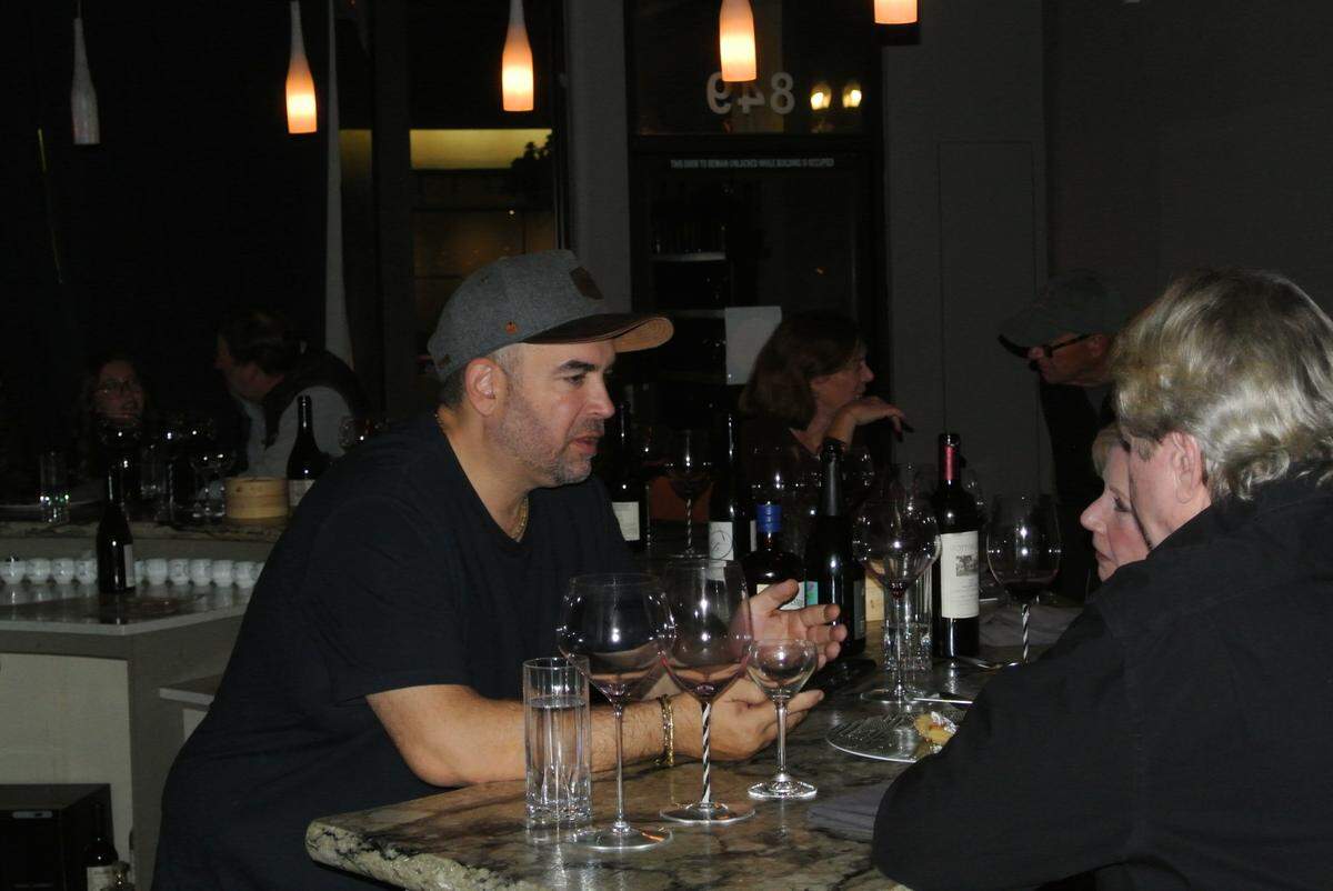 Ian Adamo, chef and sommelier at Somm’s Kitchen in Paso Robles, speaks with guests across the bar at his restaurant on December 10, 2024.