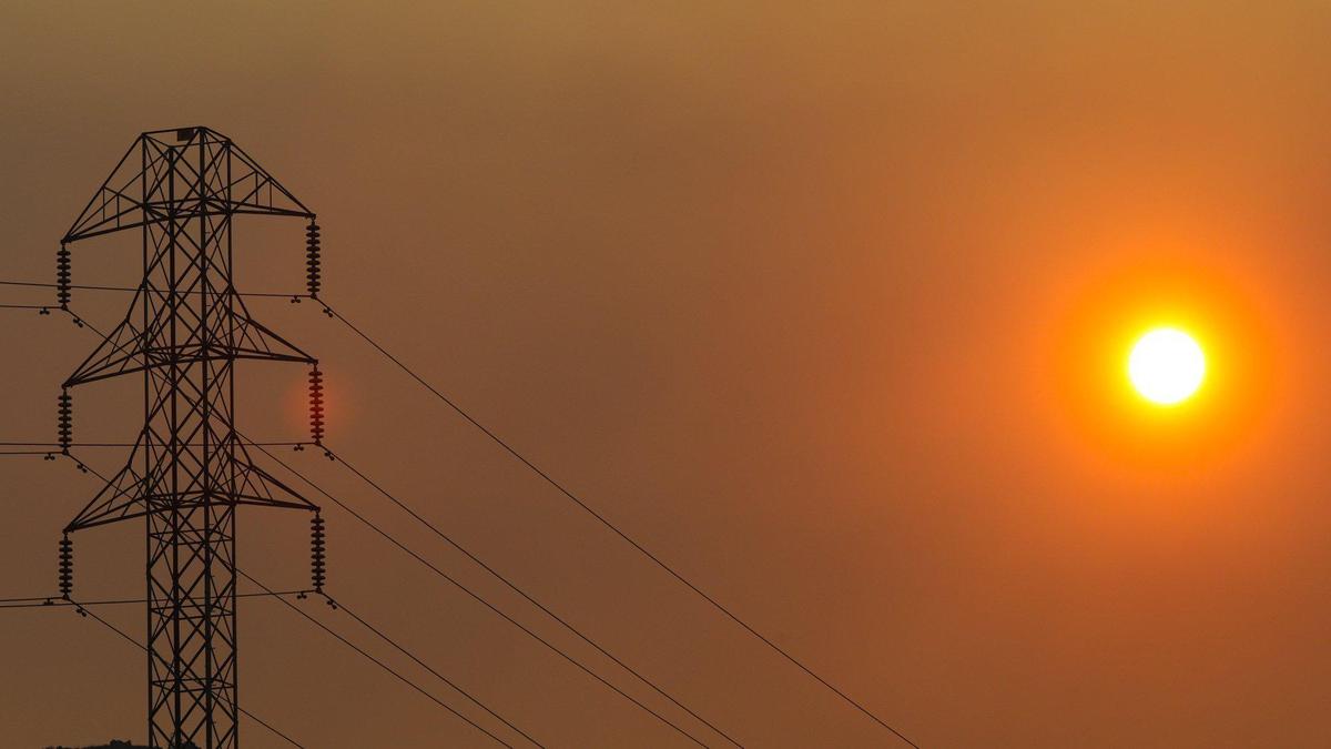 Sunrise in San Luis Obispo on Wednesday, Aug. 19, 2020, shows the sun behind PG&E high tension power lines.