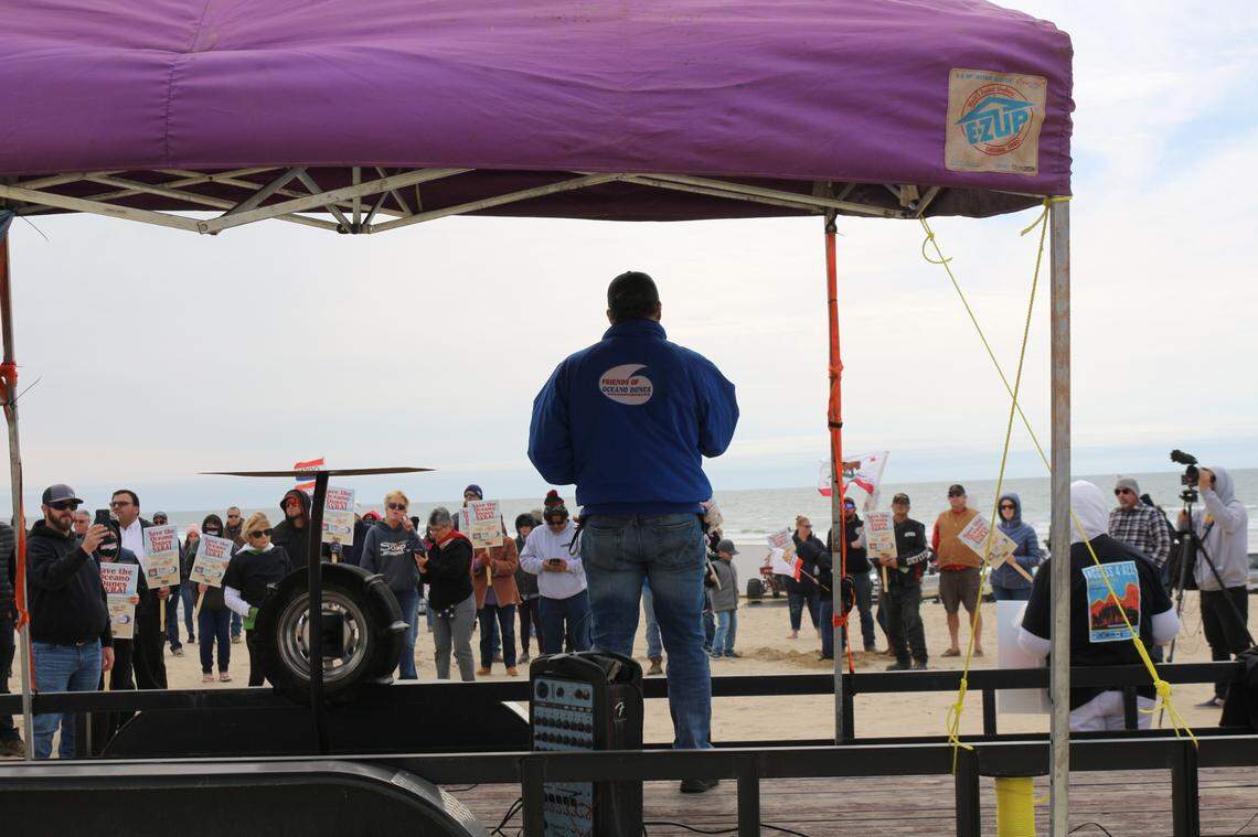 A speaker takes the stage during a Friends of Oceano Dunes, Pismo Beach Chamber of Commerce and Beach.Drive.Ride protest at Pismo State Beach on Sunday. Organizers and attendees were advocating for the continued off-highway vehicle use at the Oceano Dunes SVRA.