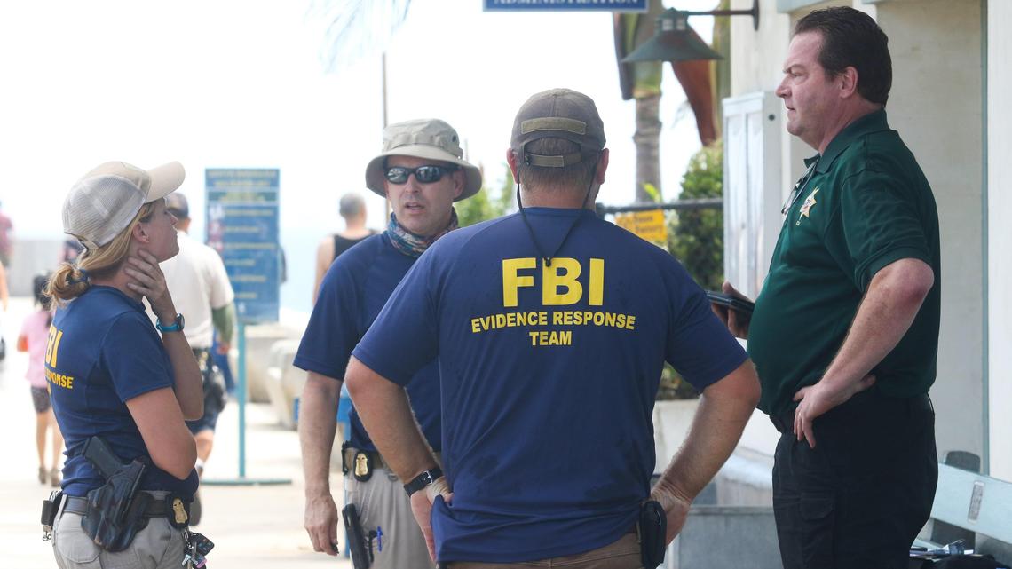 FBI investigators gather outside the harbor office in Santa Barbara on Tuesday afternoon, a day after deadly fire on the Conception dive boat.