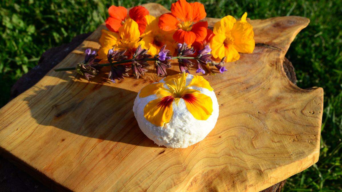 A ball of fresh Stepladder Creamery chèvre is garnished with edible flowers from the ranch.