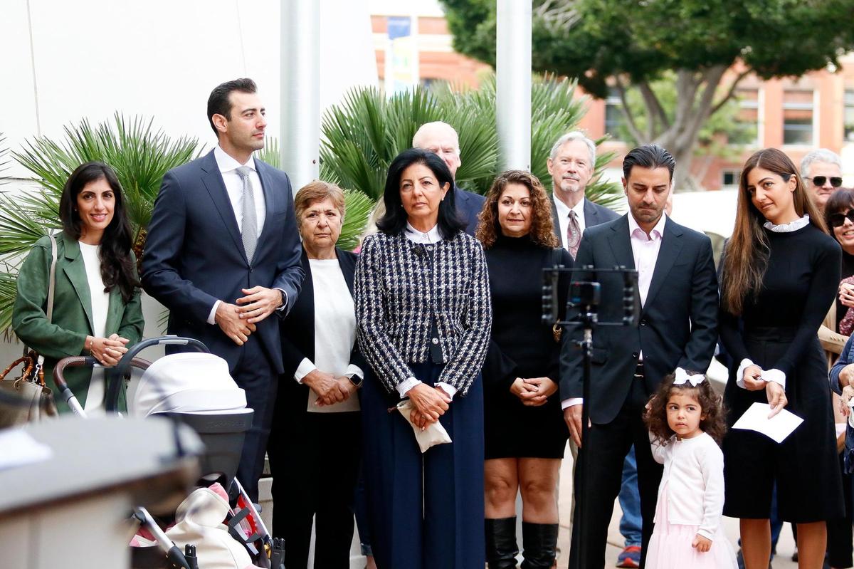 Family members listen as the new Katcho Achadjian Government Center sign was unveiled in a ceremony Friday, Oct. 20, 2023, in front of the former San Luis Obispo County Government Center.