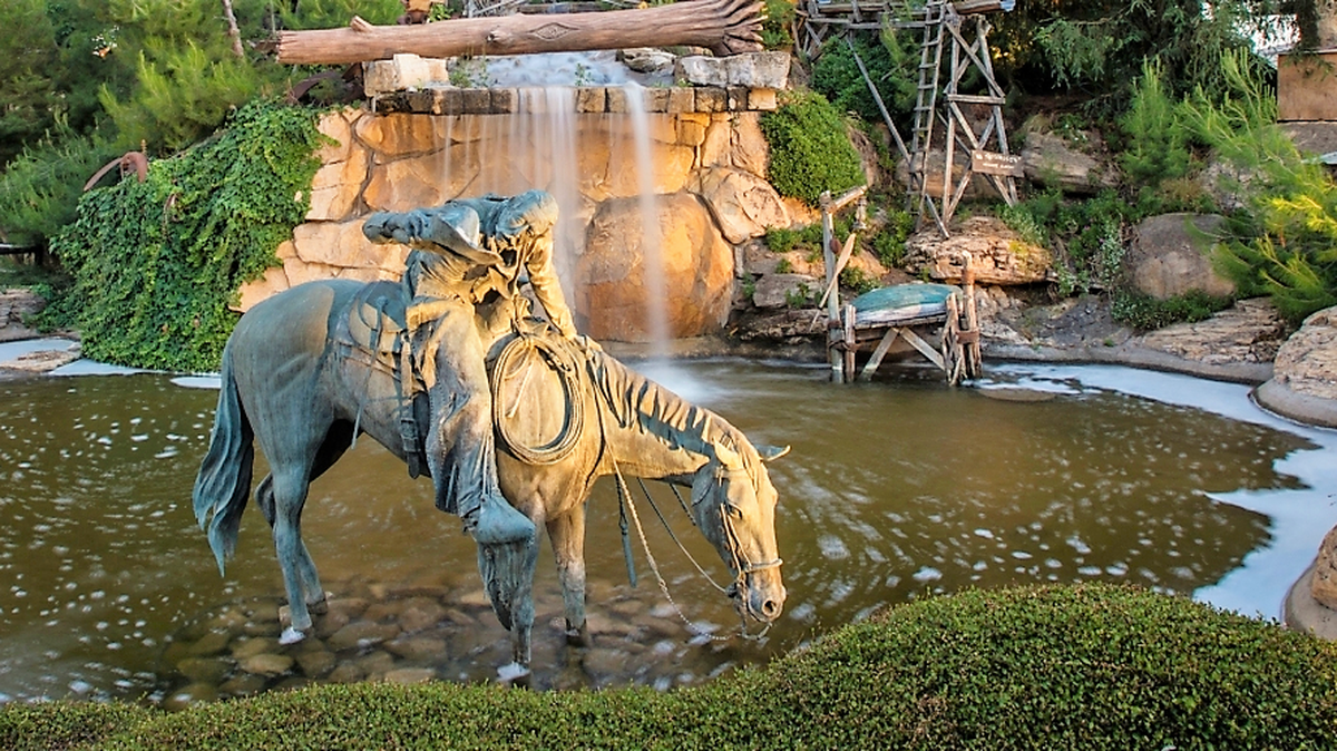 A horse statue resting in a shallow pond at the Mid-State Fair, July 2023.