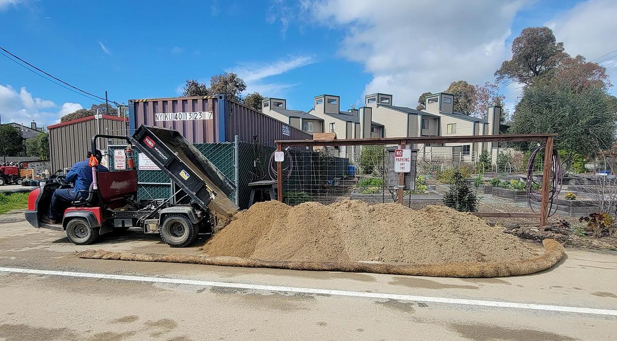Josiah Montano, golf course maintenance worker, dumps a fresh load of sand in the parking lot. The City of San Luis Obispo’s Laguna Lake Golf Course has free sand for sand bags in their parking lot.