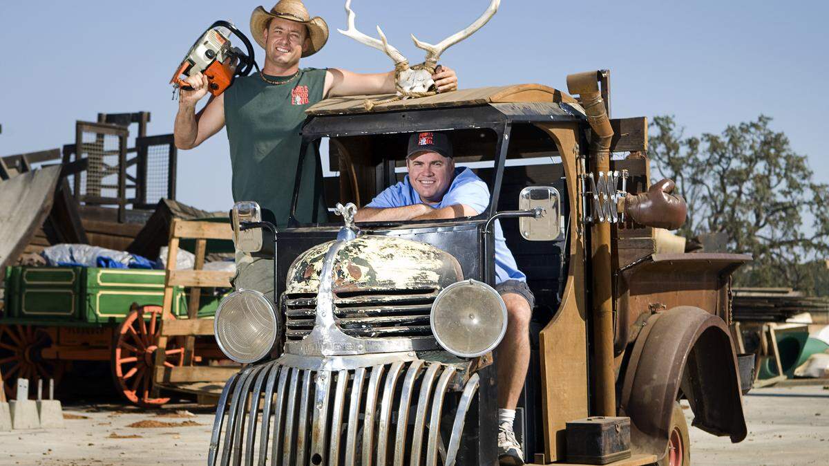 Twin brothers John, left, and Ron Daniels, co-founders of Daniels Wood Land in Paso Robles, show off their quirky, customized Cushman meter-maid car.