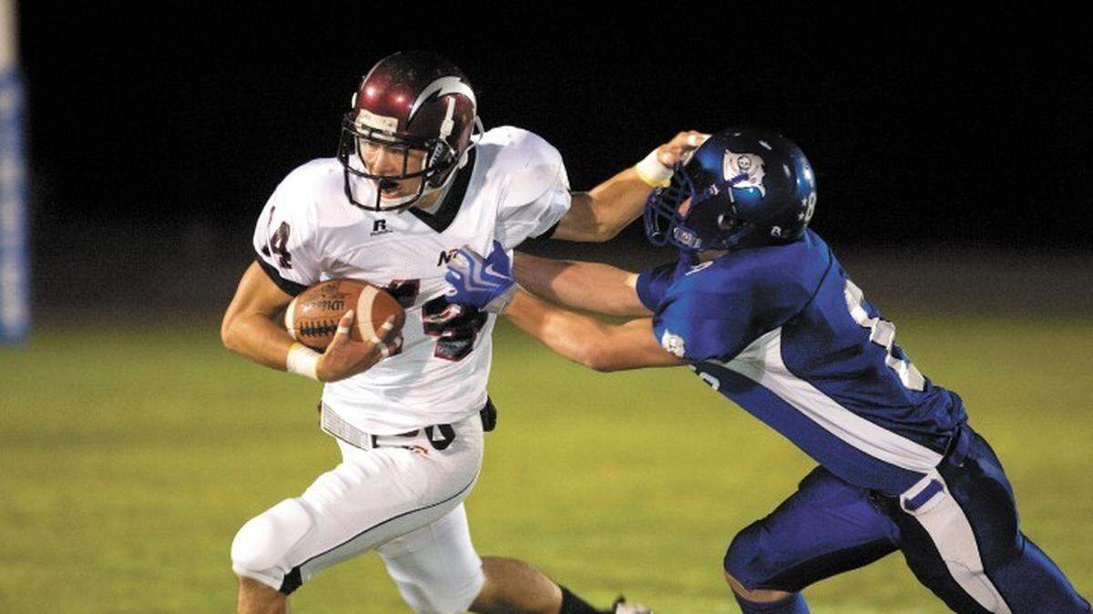 Nipomo High’s Eric Penningroth tries to break away from a Morro Bay defender during the Titans’ 27-10 win Oct. 2.