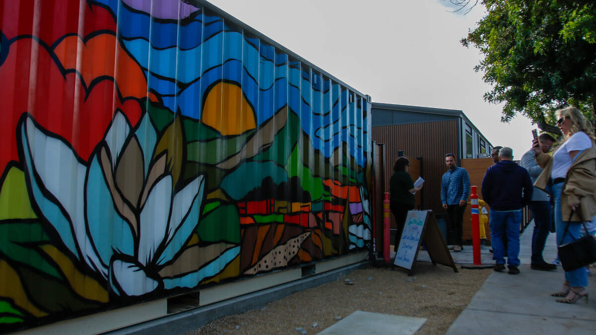 A mural by artist Scott Lakey greets visitors at the Welcome Home Village project on Monday, June 8, 2026. The project consists of 40 3D-printed permanent supportive housing units and 14 interim supportive housing units with wraparound supportive services onsite.