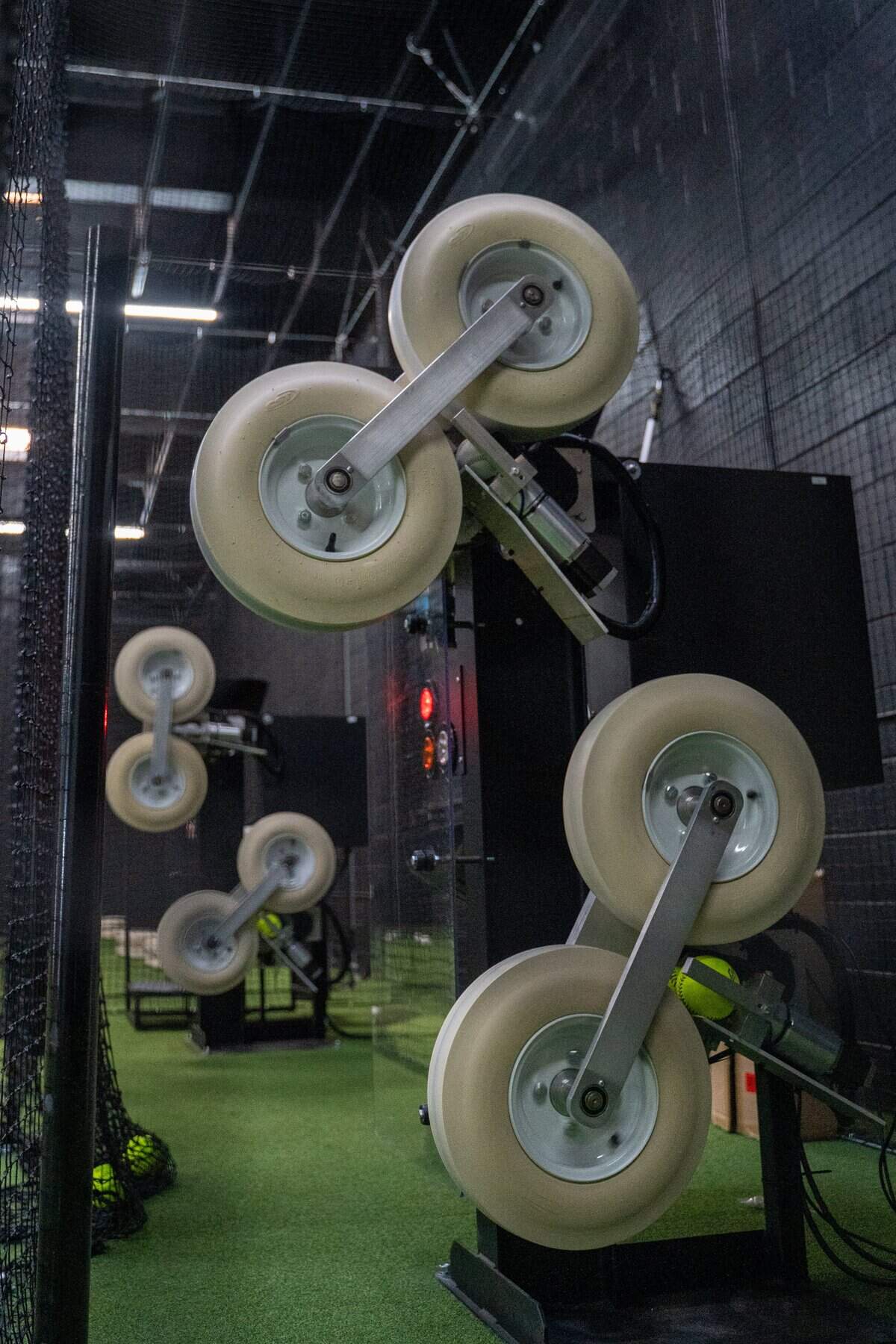 A pitching simulator warms up to throw a softball at SLO Swing Sports on Friday, Oct. 10, 2025. The simulator can adjust speed, pitch type and pitch placement based on each player.
