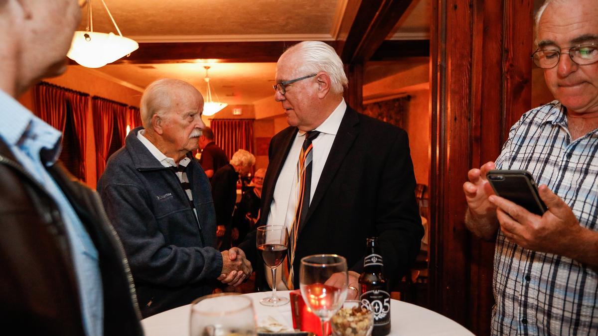 San Luis Obispo mayor candidate T. Keith Gurnee, center, shakes hands with supporter Bob Williams during an election night gathering with supporters Tuesday at Cafe Roma.