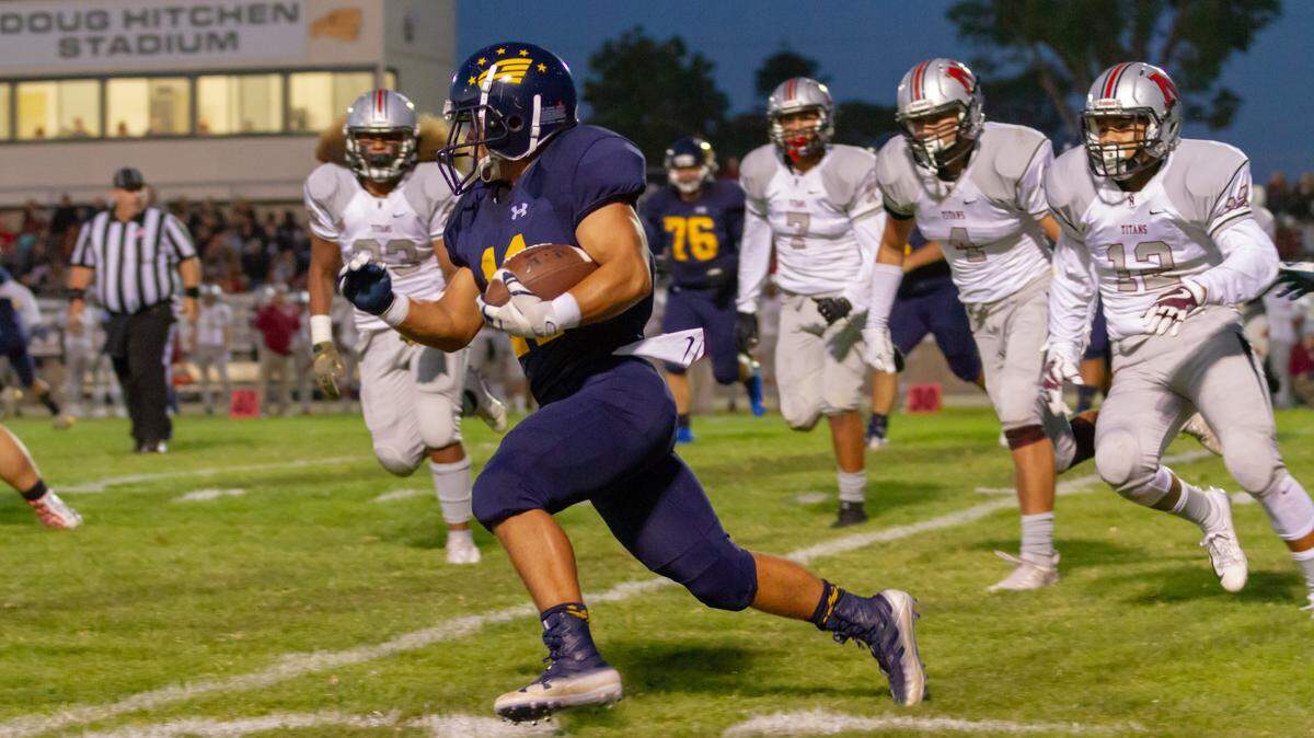 Arroyo Grande High School junior running back Elijah Castro carries the ball in a nonleague football game earlier this year against Nipomo.