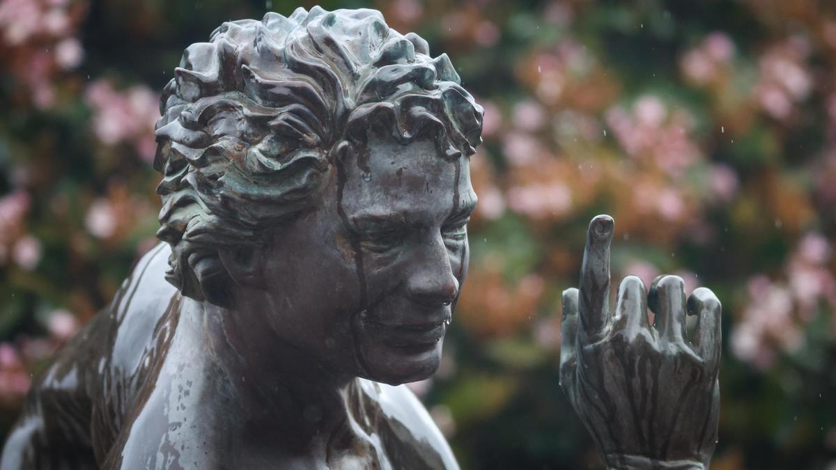 The Downtown Centre’s “Puck” statue by sculptor Elizabeth MacQueen appears to be crying and pointing at the storm clouds as rain falls in downtown San Luis Obispo during the first significant storm of 2022 on March 28.