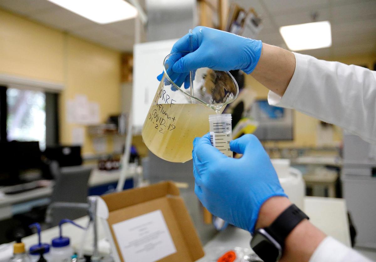 Tanner Duncan, a water quality lab analyst for the City of San Luis Obispo, preps a sample of wastewater to be sent out for testing. The SLO County Public Health Department uses wastewater surveillance to monitor COVID prevalence here.