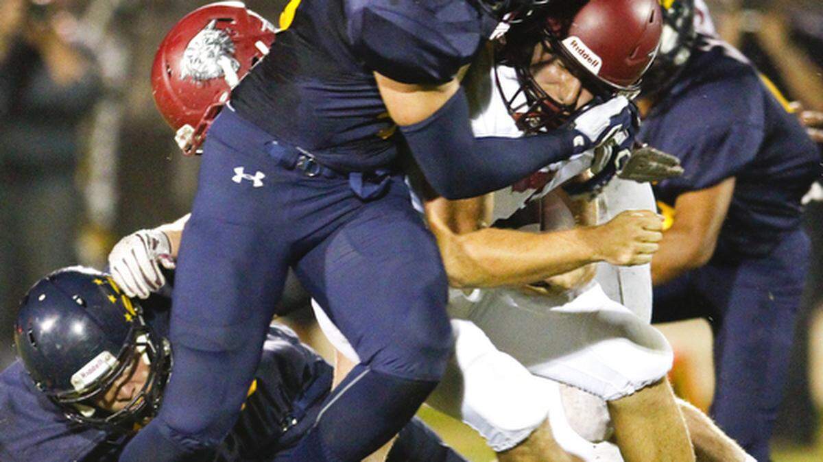 Arroyo Grande's Sam Ness stops Paso Robles quarterback Justin Davis on a 4th down play in the first quarter Friday night.
David Middlecamp
10-9-2015