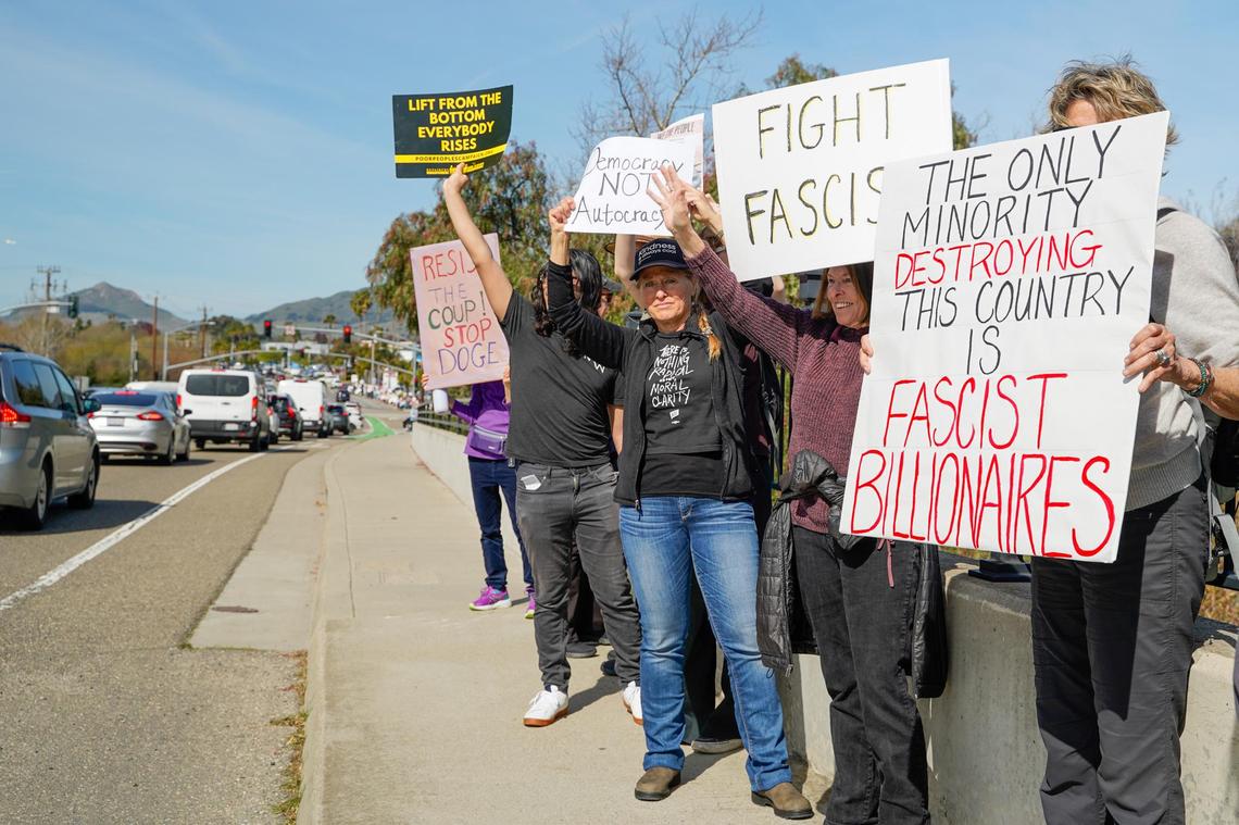 Many protesters who attended a demonstration on Los Osos Valley Road Monday, Feb. 17, 2025, against the second Donald Trump administration said they were concerned with the role of Elon Musk and his newly formed Department of Governmental Efficiency. Many called Trump and Musk fascists for their persecution of immigrants, transgender Americans and other minorities.