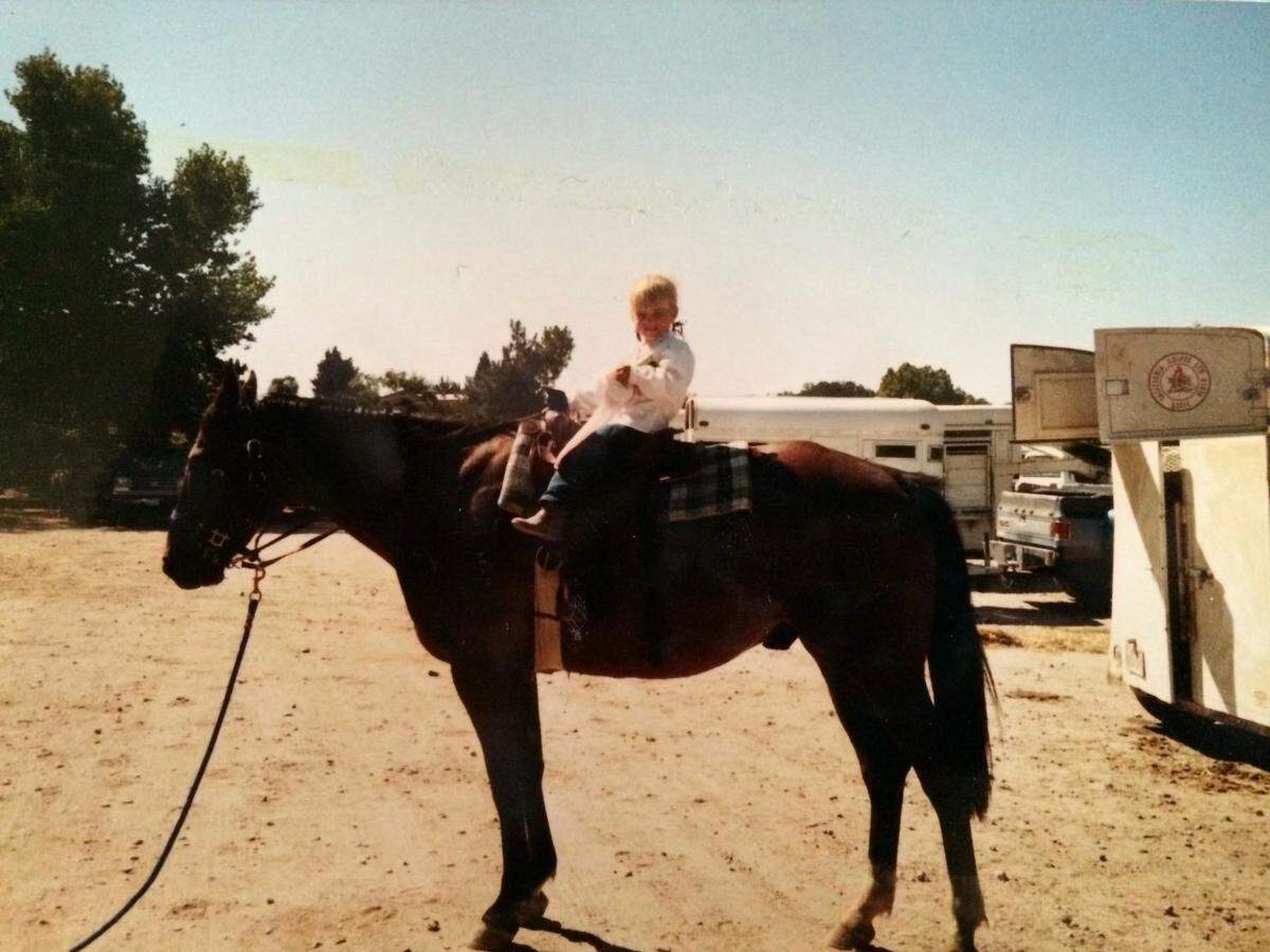 Callie Twisselman riding a horse on the family ranch at 3-years-old.