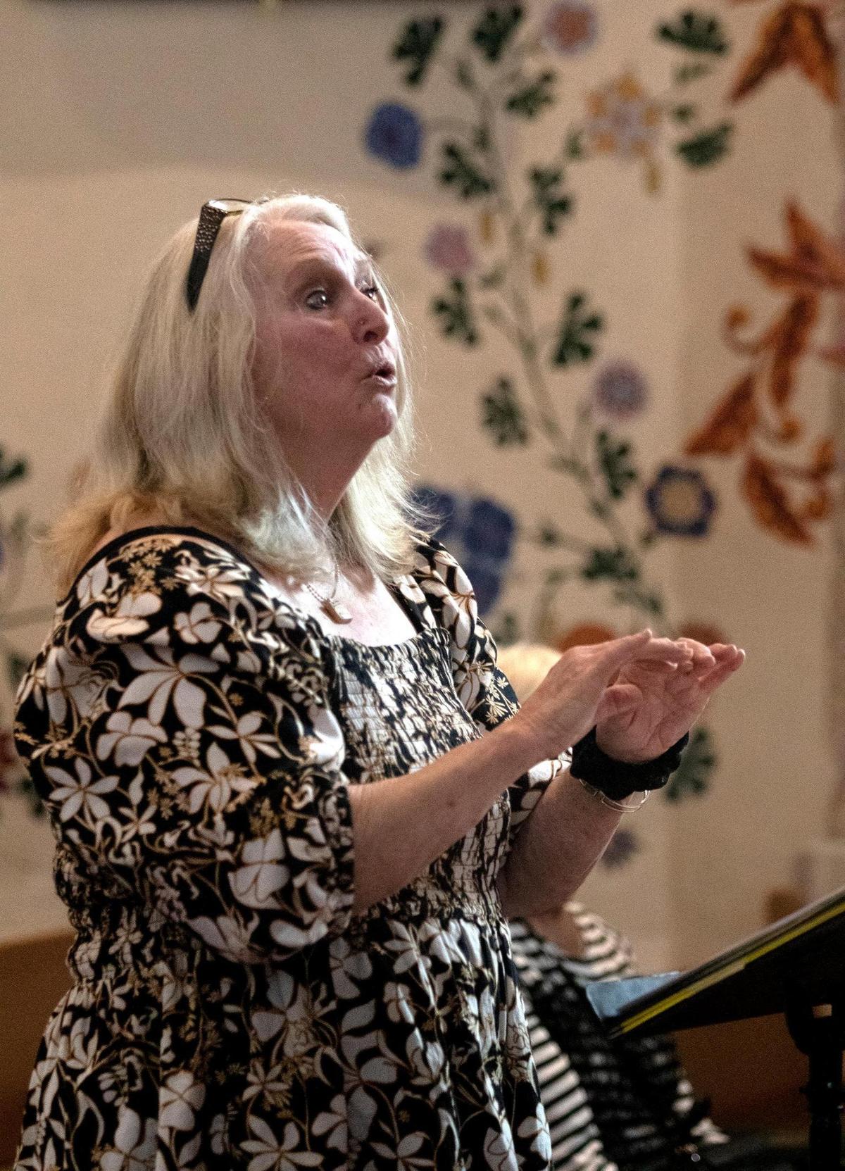 Melody Svennungsen, artistic director for the Central Coast Youth Chorus, leads a memorial sing-along at the Mission San Luis Obispo on Feb. 24, 2024, in honor of longtime choir director Gary Lamprecht, who died on Wednesday.