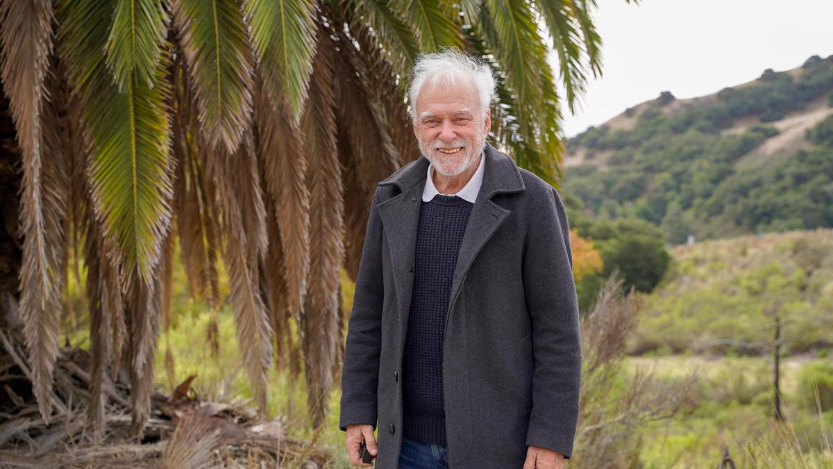 Rob Rossi, the current owner of 3544 Vista Del Ciudad, stands near a tree near the base of the property’s 1.4-mile driveway near Highway 101 Friday, Dec. 13, 2024. Originally constructed in 1951 by Alex Madonna, the property was at the core of a manslaughter trial that grabbed local and international headlines for more than a year the same year it was built.