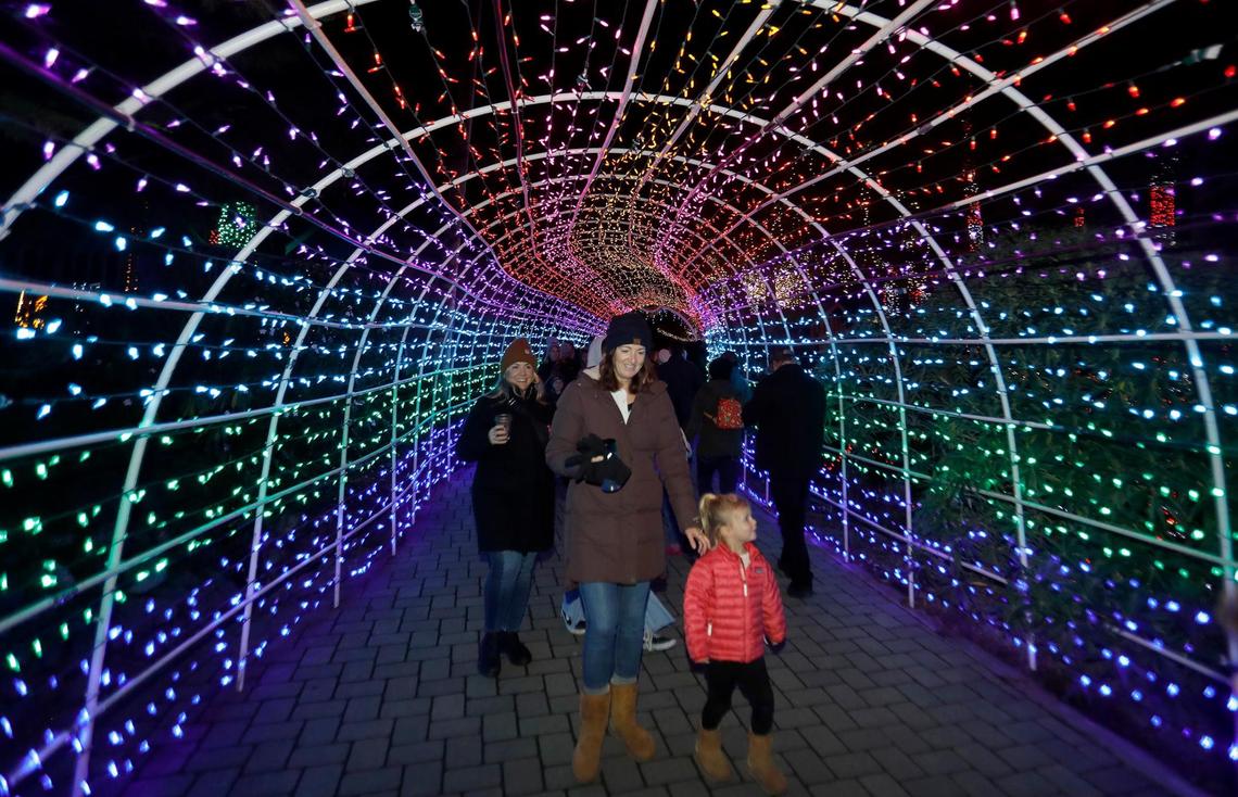 Visitors take pictures of the Christmas Lighted Tunnel at the Cambria Christmas Market on Wednesday, Dec. 14, 2022.