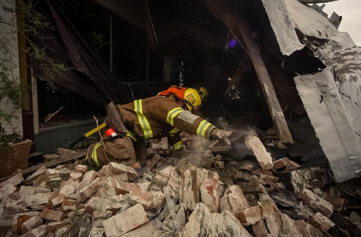 Firefighter searches the rubble on Pine Street in Paso Robles after an unreinforced masonry building collapsed during the San Simeon Earthquake, Dec. 22, 2003.