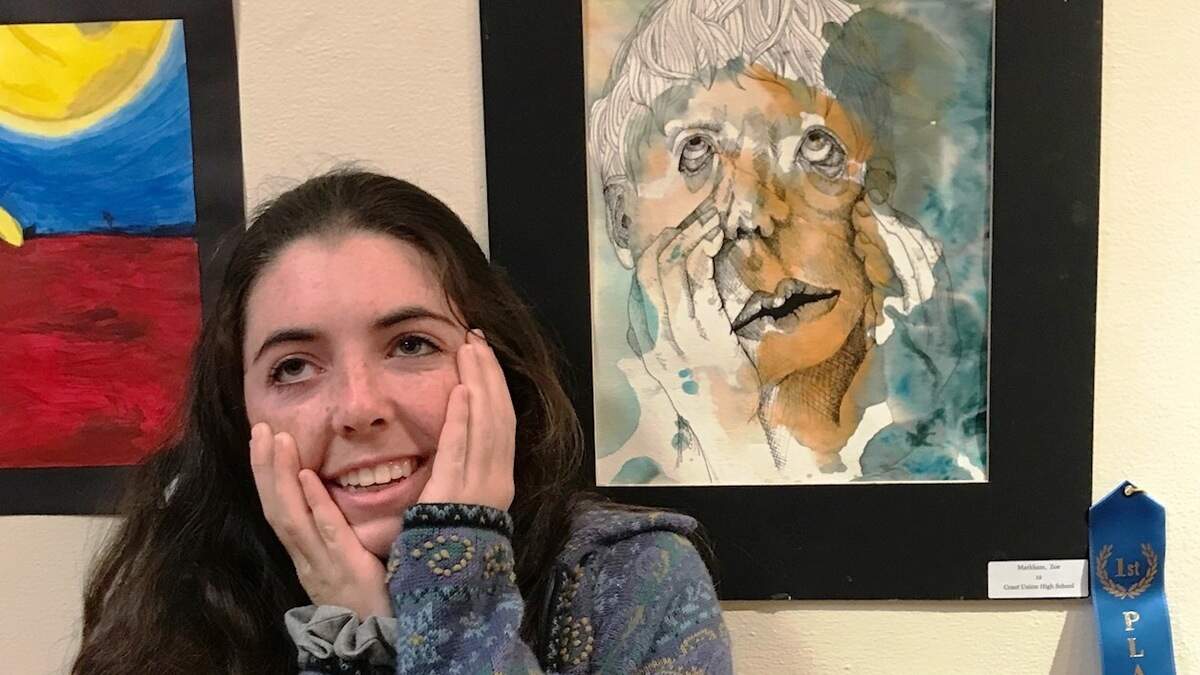 Zoe Markham, who earned first-place honors among high school seniors, with her painting, "Senior Stress."