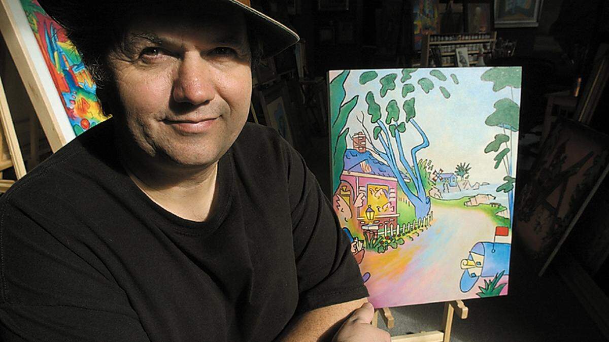 John Landon, seen here in 2001 with one of his paintings, was known for his dramatic use of color.