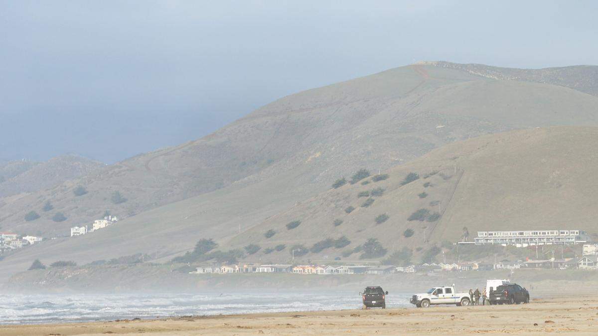 Investigators at the scene of a fatal shark attack north of Morro Rock. The water was closed Dec. 24, 2021.