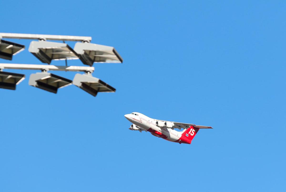 An air tanker responds to a vegetation fire burning behind San Luis Obispo High School near Lizzie Street on Oct. 30, 2023.