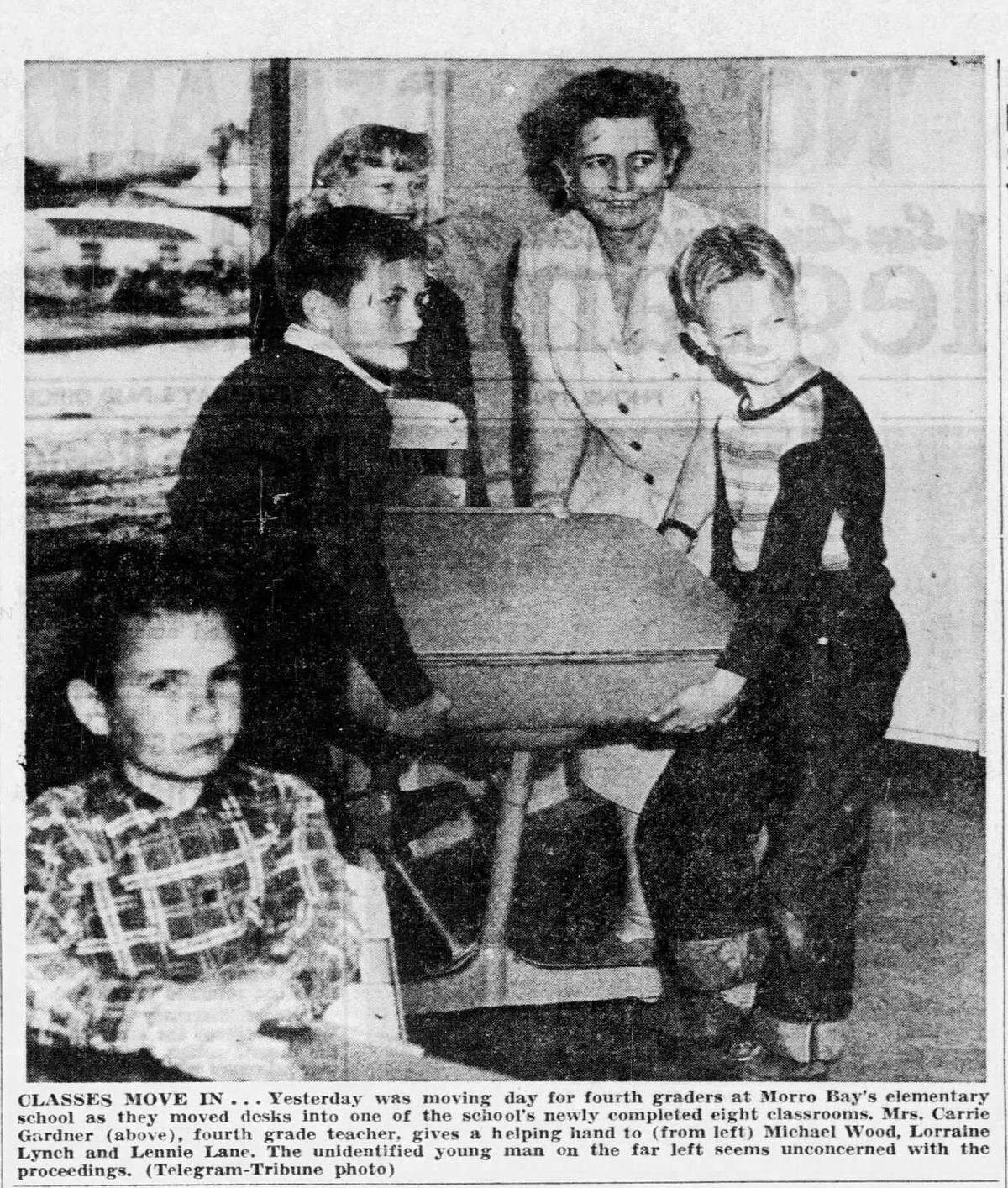 Yesterday was moving day for fourth graders at Morro Bay’s elemantry school as they moved desks into one of the school’s newly completed eight classrooms on Jan. 25, 1954. Mrs. Carrie Gardner, fourth grade teacher, gives a helping hand to (from left) Michael Wood, Lorraine Lynch and Lennie Lane. The unidentified young man on the far left seems unconcerned with the proceedings.
