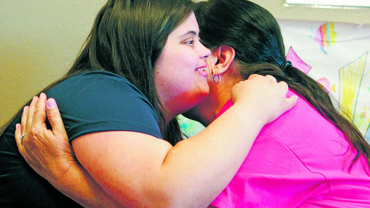 Tricia Allessi, 27,  a Paso Robles woman with Down Syndrome has been accepted into the Fresno State University independent living program. Here she gets a hug from mom Cecile.
David Middlecamp
7-29-2015