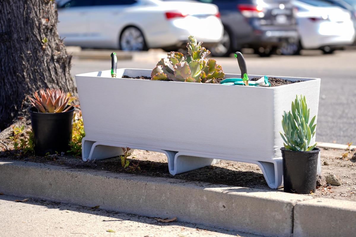 Succulent plants from Growing Grounds Nursery were planted in 3D printed planter boxes at the Welcome Home Village groundbreaking on Wednesday, June 25, 2025. The 54 cabin homes planned for the village will be 3D printed by developer Azure Printed Homes.