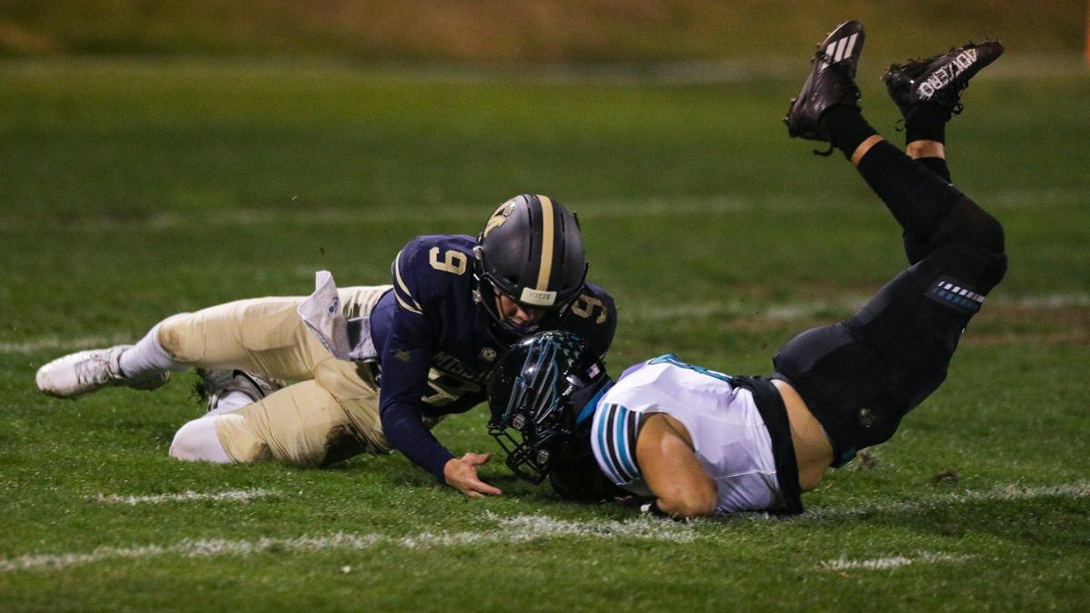An errant snap led to a turnover as Colby White and Carlos Calderon dive for the ball. Calderon recovered for Kennedy. Mission Prep fell to Kennedy 27-14 (from Delano) in a football playoff Nov. 18, 2022.