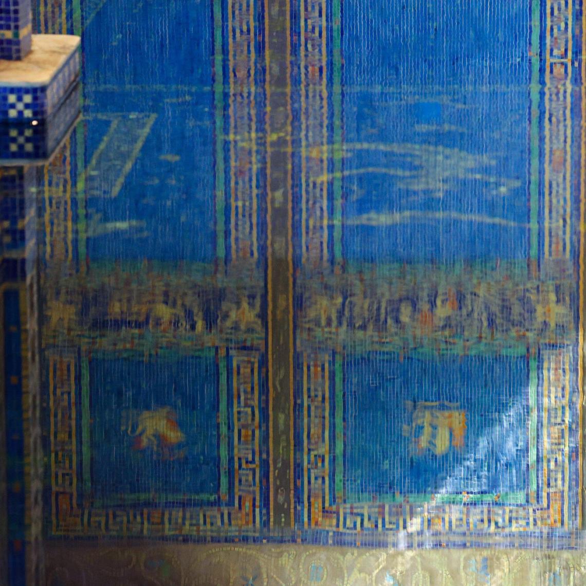 The gold and blue tile of the Roman Pool is reflected in the water at Hearst Castle.
