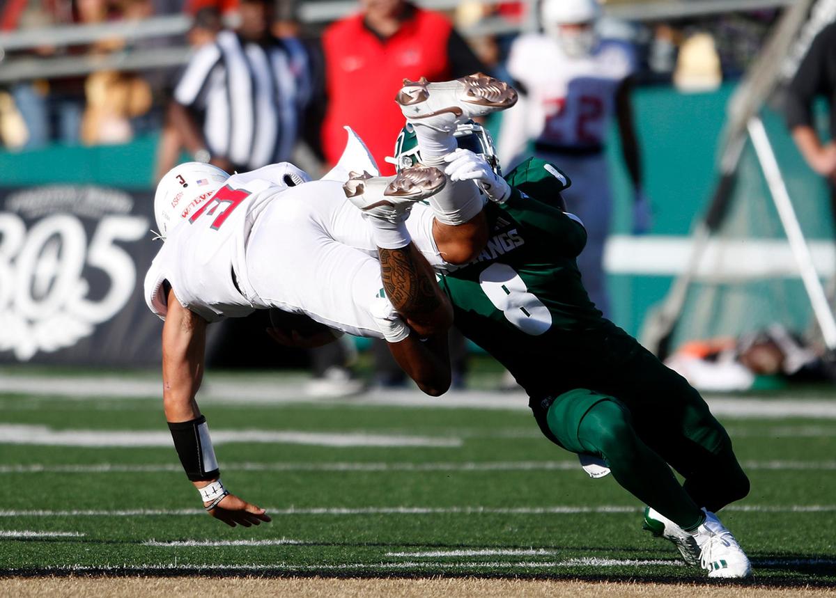 Shakobe Harper tackles Wolves Malcolm Liufau as Cal Poly beat Western Oregon 31-14 in a college football game on Sept. 14 2024, in San Luis Obispo.