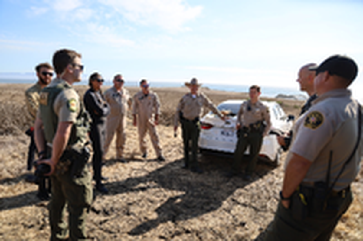 Divers from the San Luis Obispo County Sheriff’s Office were lowered into the water near a capsized boat by helicopter. Search efforts continued on shore and in the air.