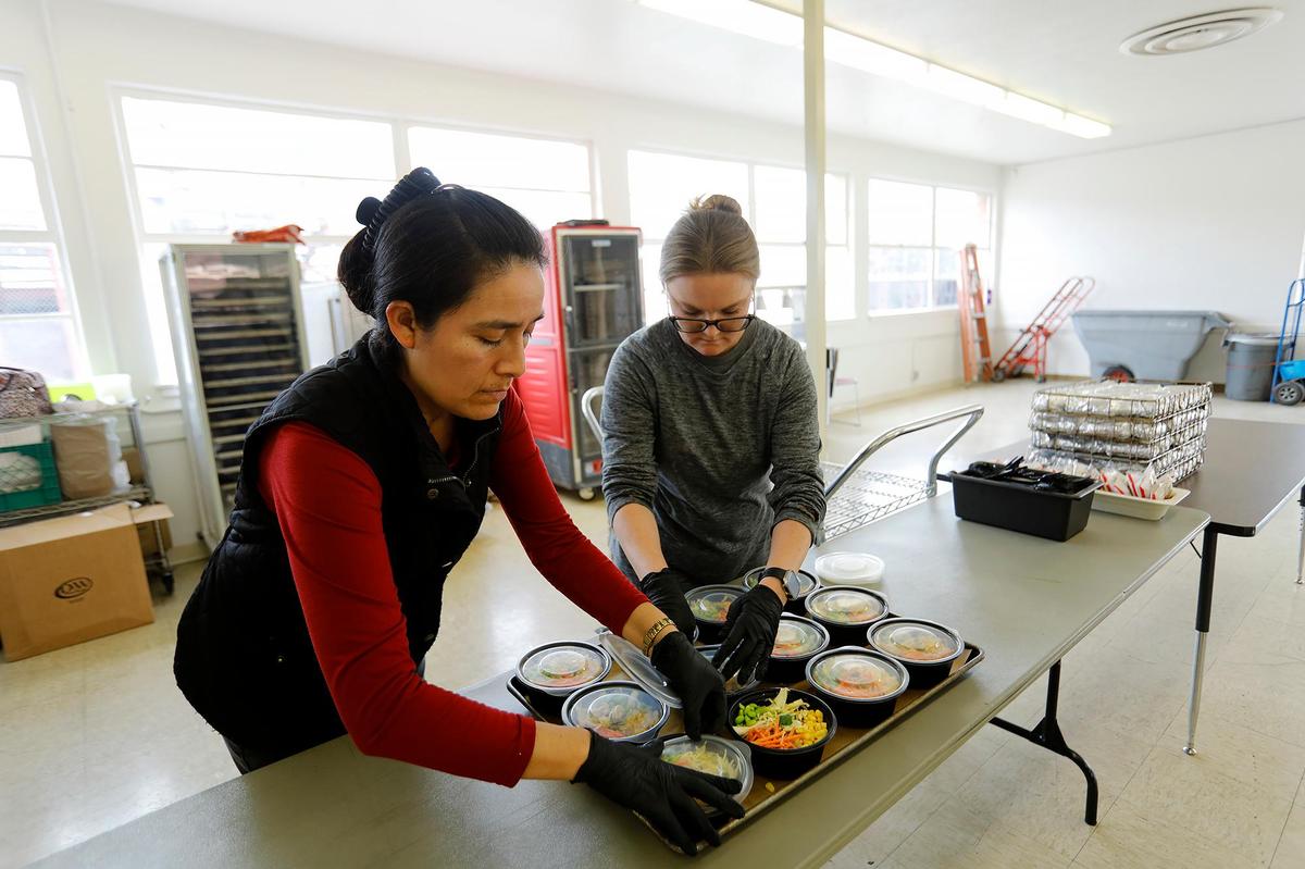Food service workers Patricia Chavez, left, and Elizabeth Cardenas serve ramen bowls at Flamson Junior High School in Paso Robles, where students enjoy from-scratch meals made with fresh ingredients from local farms and ranches.