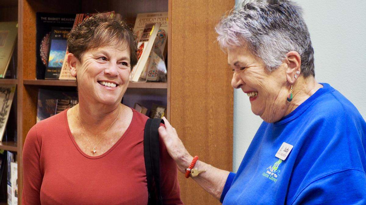 Judy Butler, left, and Barbara Gray Bronson share a laugh at the used bookstore at the Cambria Public Library.
