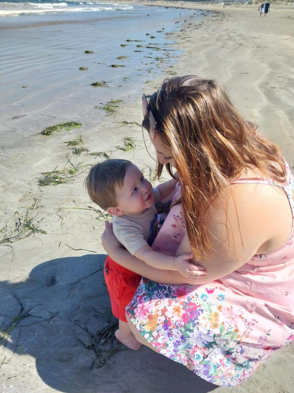 Brianna Mae Thomas with her nearly 1-year-old son, Sean, at the beach in Morro Bay.