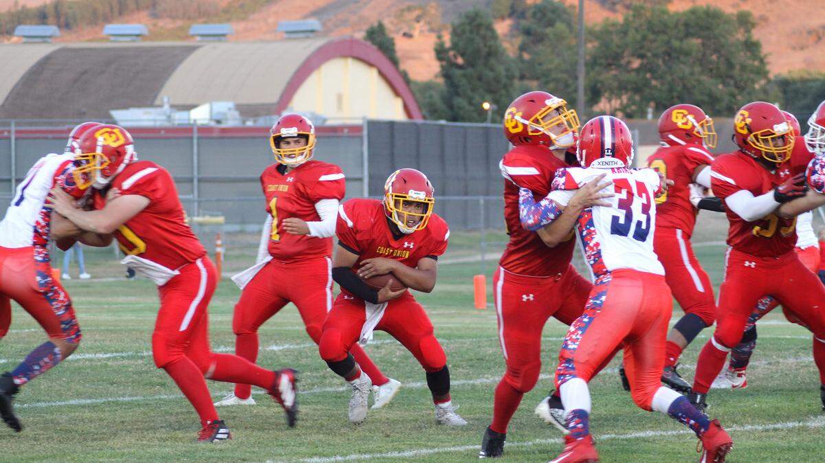 Coast Union High School’s Emi Pena had a huge hole to run through on Friday, Sept. 13, during the win over Riverdale thanks to Spencer Magnuson (blocking the defensive end on the left) and Gabe Terrasas blocking number 33.