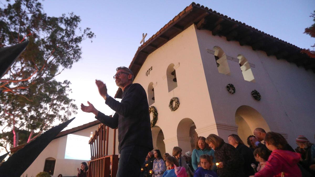 Rabbi Micah Hyman of Congregation Beth David leads traditional Hanukkah songs in front of Mission San Luis Obispo after the menorah lighting on Dec. 7, 2023.