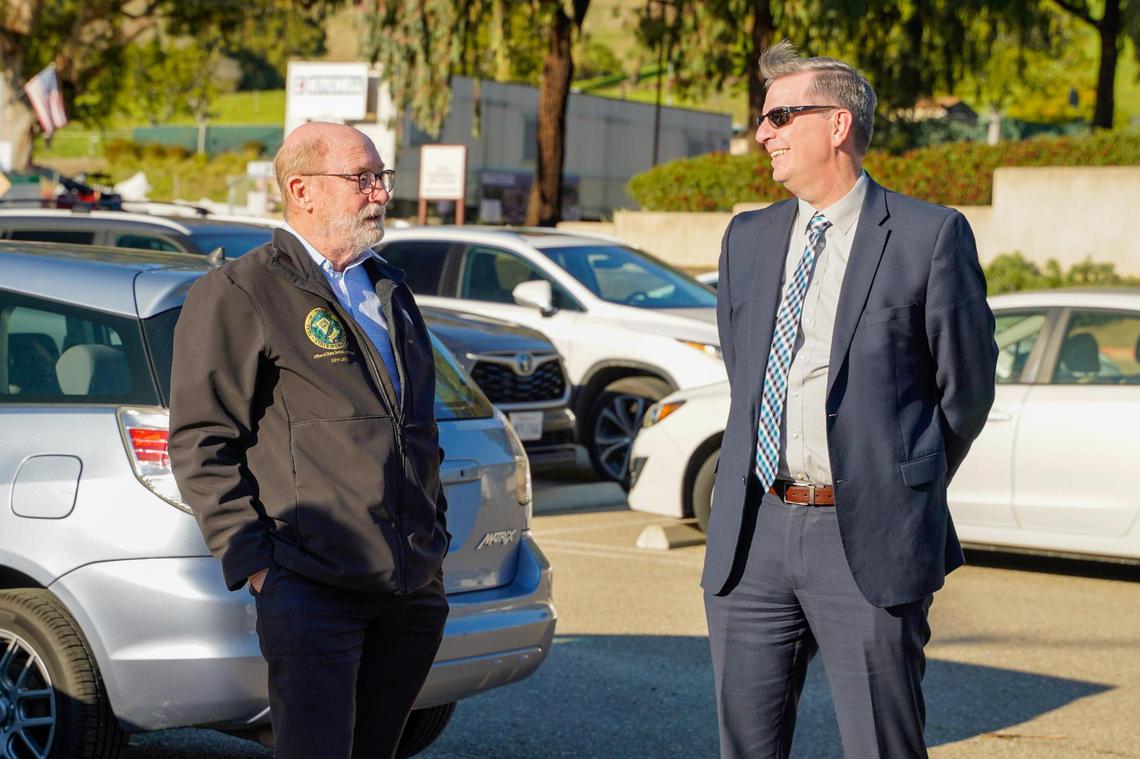 California state Sen. John Laird, left, and San Luis Obispo County Department of Social Services Devin Drake speak at the future location of the Welcome Home Village transitional housing project in San Luis Obispo on Thursday, Feb. 20, 2025.