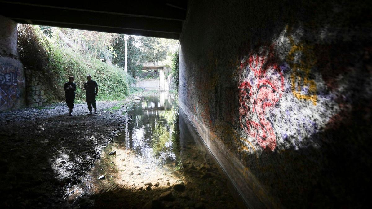 San Luis Obispo city biologist Freddy Otte at right shows a visitor some of the cleanup efforts in tunnel that channels San Luis Obispo Creek under Mission Plaza on Oct. 28, 2024. The creek is home to steelhead trout, which are listed as threatened under the Endangered Species Act.