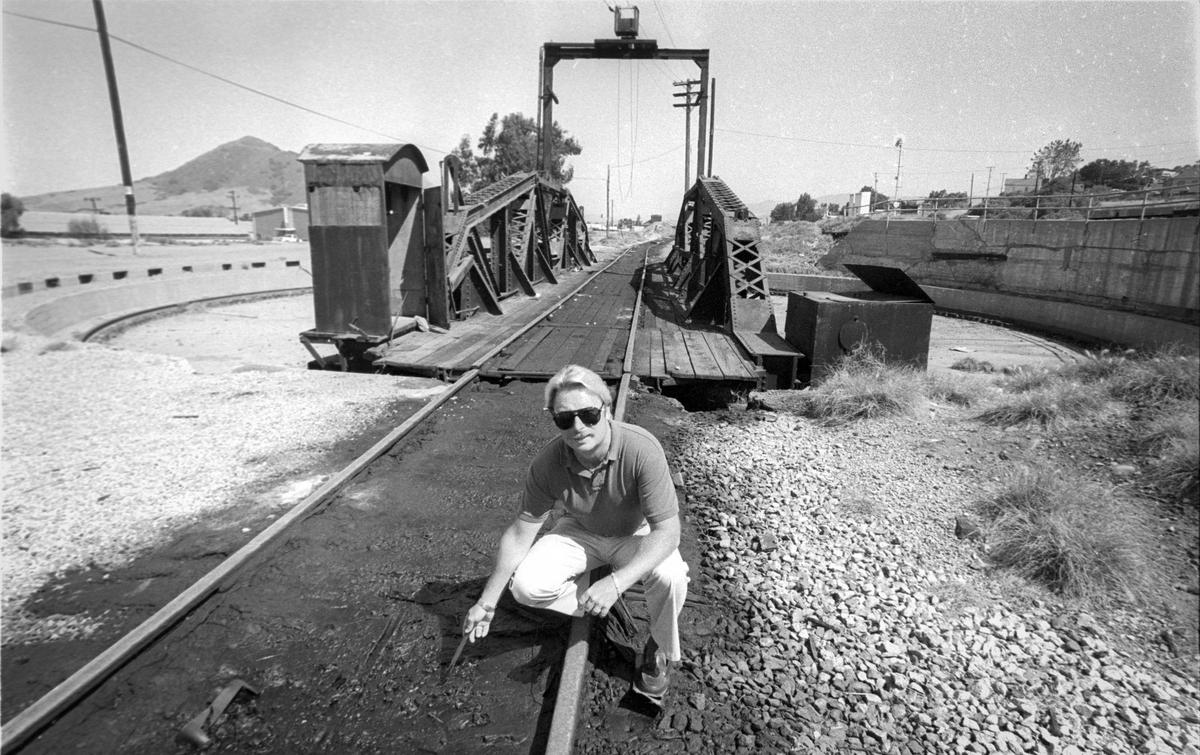 Randy Miller, hazardous materials inspector, shows oil pollution around the old Southern Pacific roundhouse in San Luis Obispo on June 13, 1988.