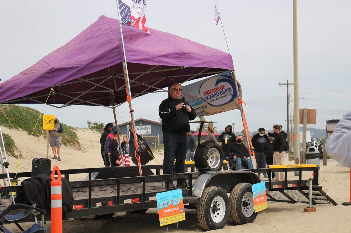 Jim Suty, president of Friends of Oceano Dunes, speaks at a protest held Sunday to demand the California Coastal Commission allow continued off-highway vehicle use at the Oceano Dunes SVRA.