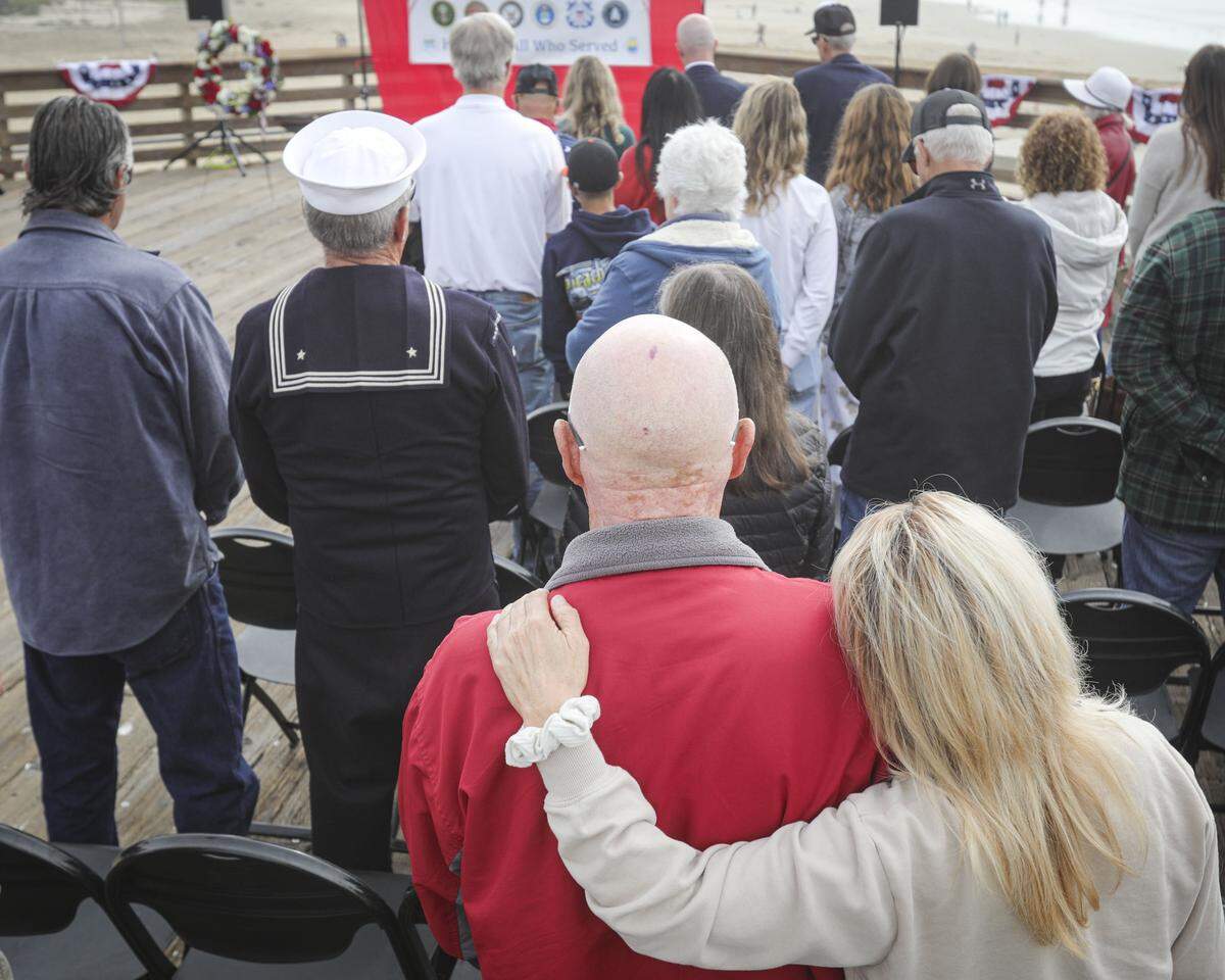 U.S. Army veteran Eddie Fisher gets a hug from daughter Amanda Clegg. About 200 people attended a Veterans Day Celebration at the Pismo Beach Pier on Nov. 1, 2025.