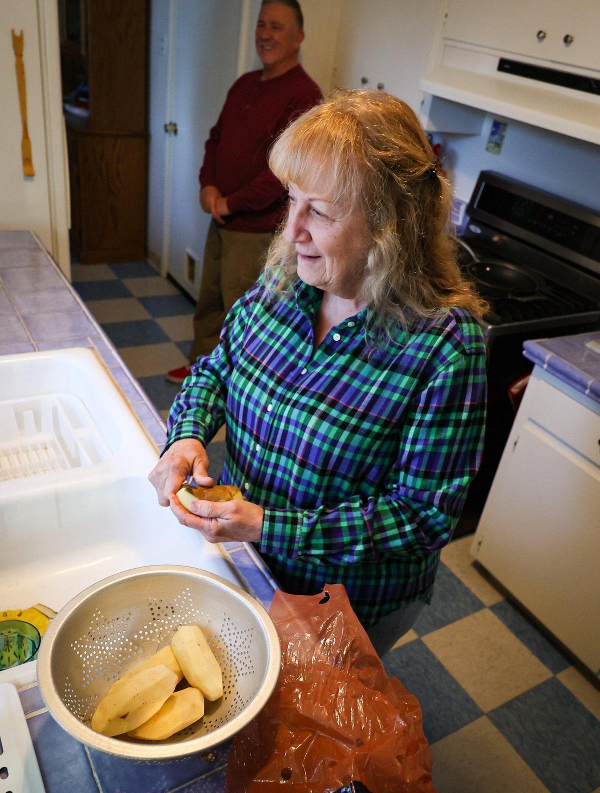 Sandra Gonzales peels potatoes for dinner. Sandra and Chuck Gonzales have been caregivers in the Cambria area and have had to move four times in five years.